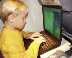 Kid using laptop on airplane